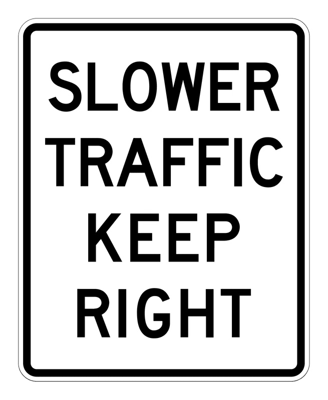 Slower Traffic Keep Right Sign road sign — White vertical rectangle reading SLOWER TRAFFIC KEEP RIGHT